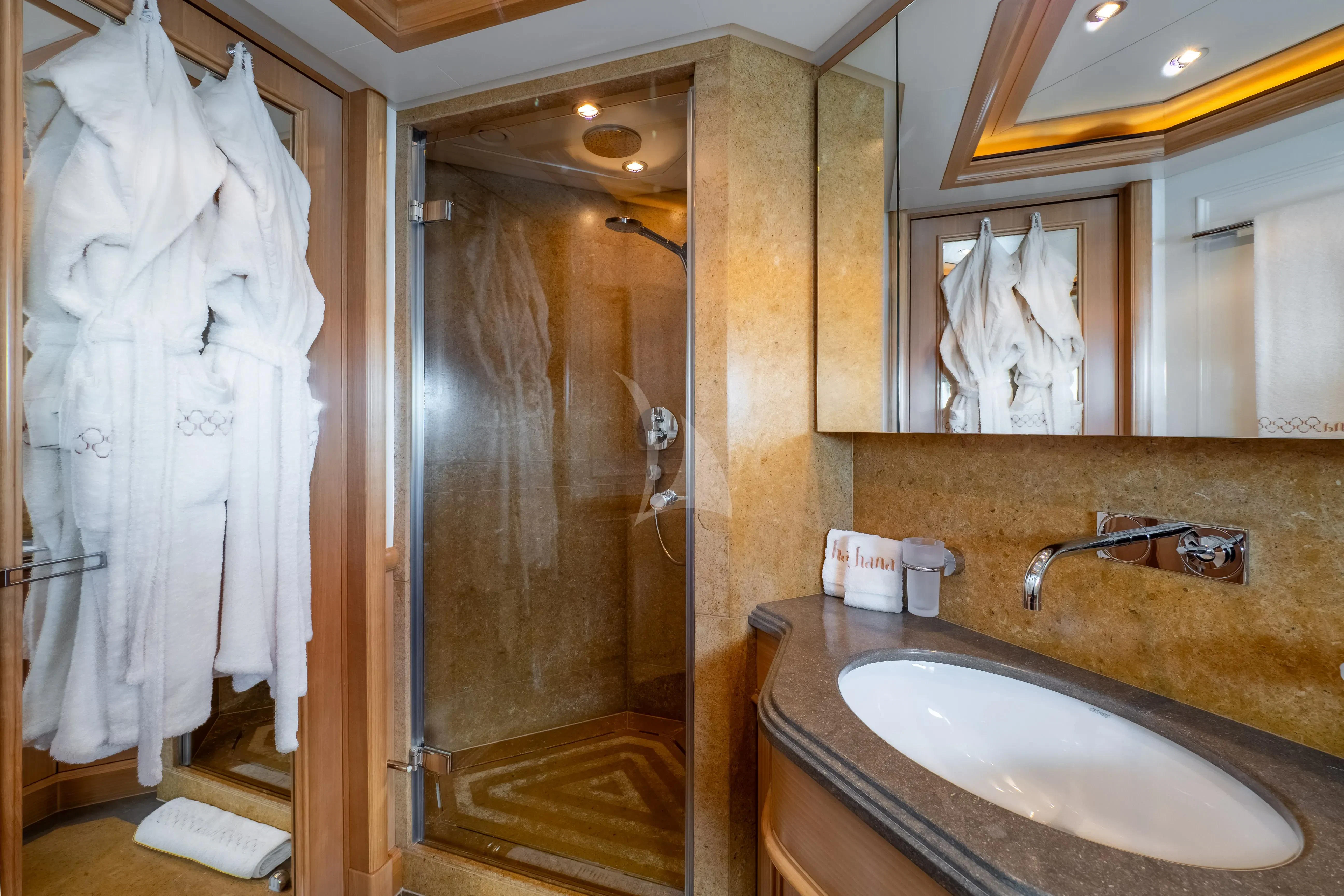 a bathroom with a sink and a shower aboard HANA Yacht for Charter