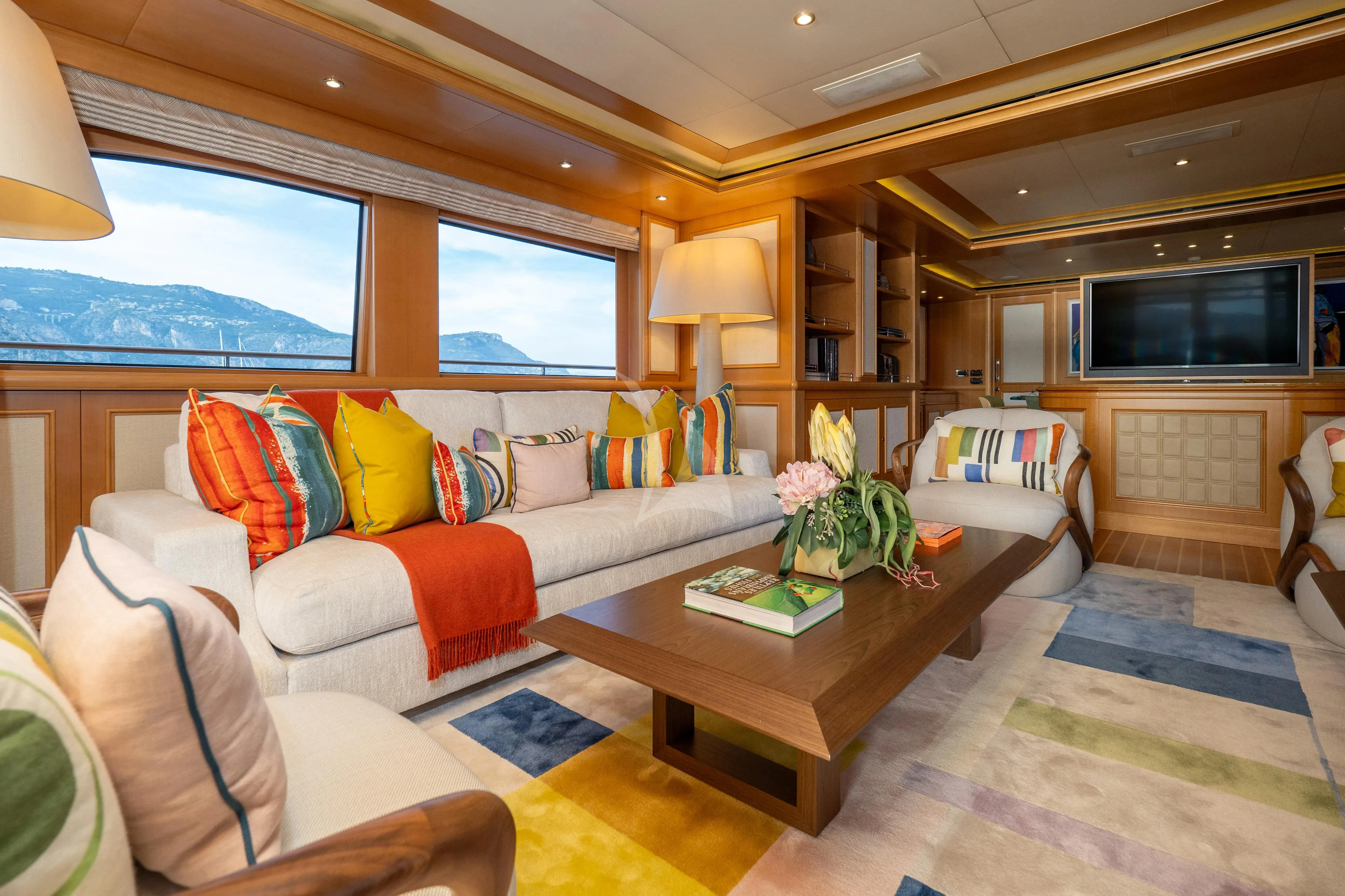 a living room with a couch and a coffee table aboard HANA Yacht for Charter