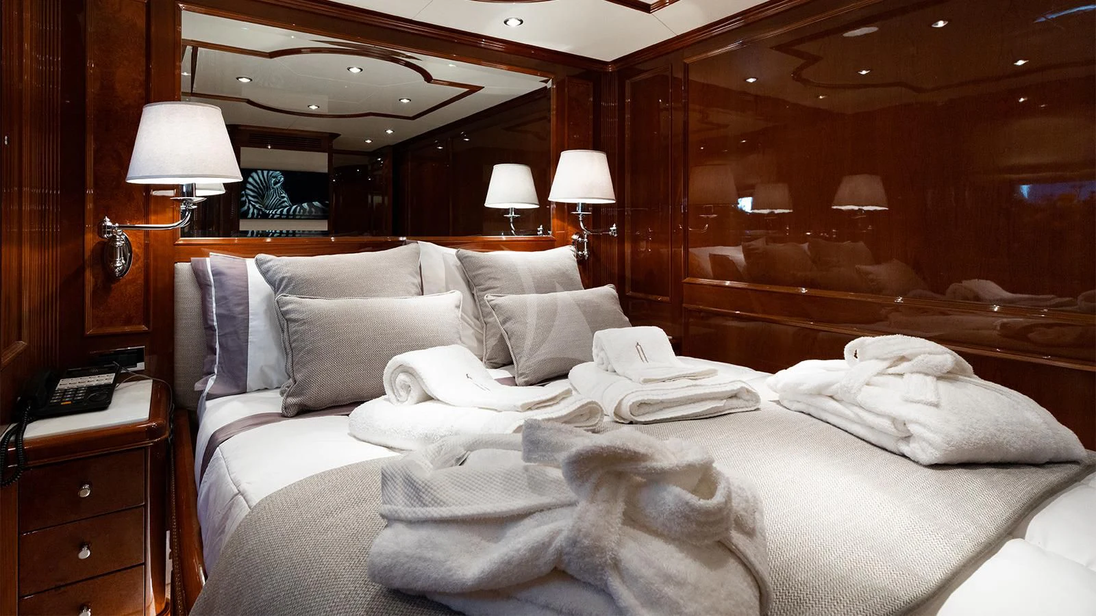 a bed with white sheets aboard OAK Yacht for Charter