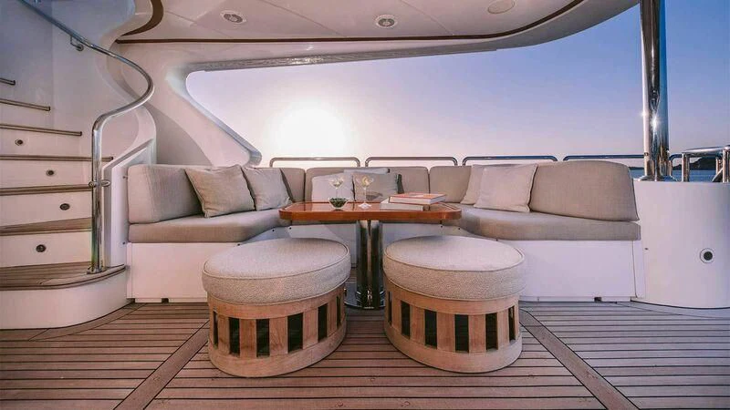 a boat with a table and chairs aboard OAK Yacht for Charter