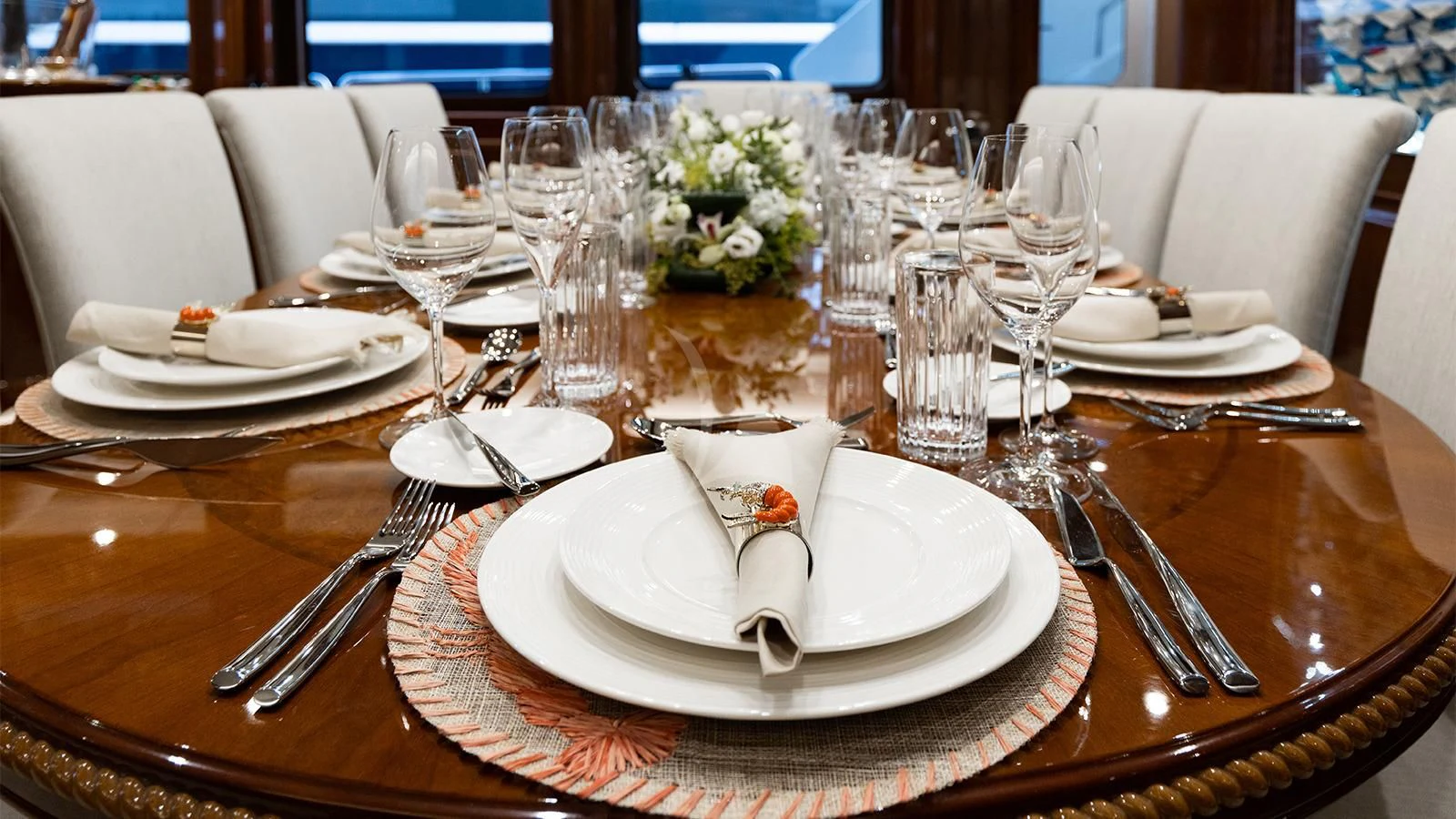 a table set with plates and silverware aboard OAK Yacht for Charter
