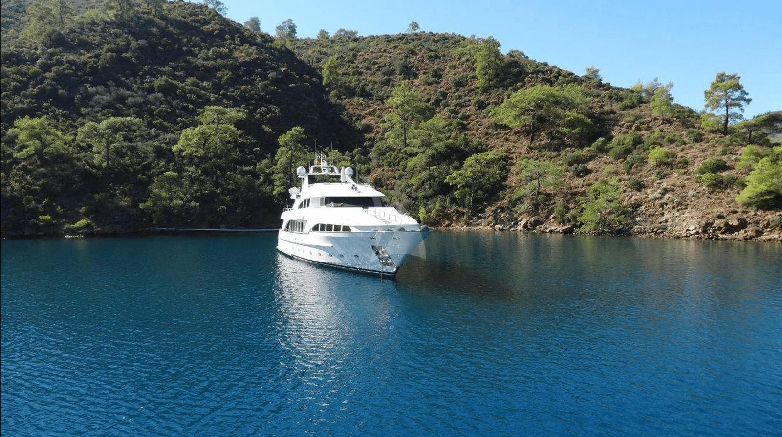 a white boat on the water aboard OAK Yacht for Charter