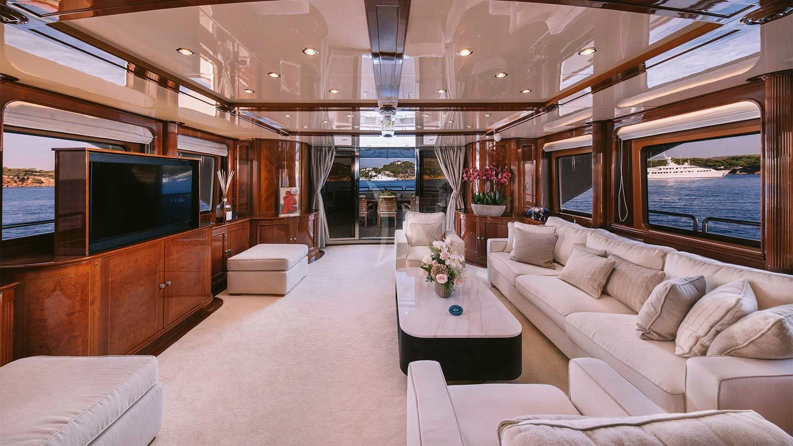 a living room with a large television aboard OAK Yacht for Charter