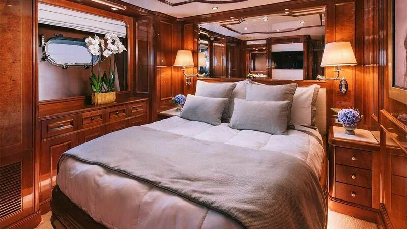 a bed with white sheets and pillows aboard OAK Yacht for Charter