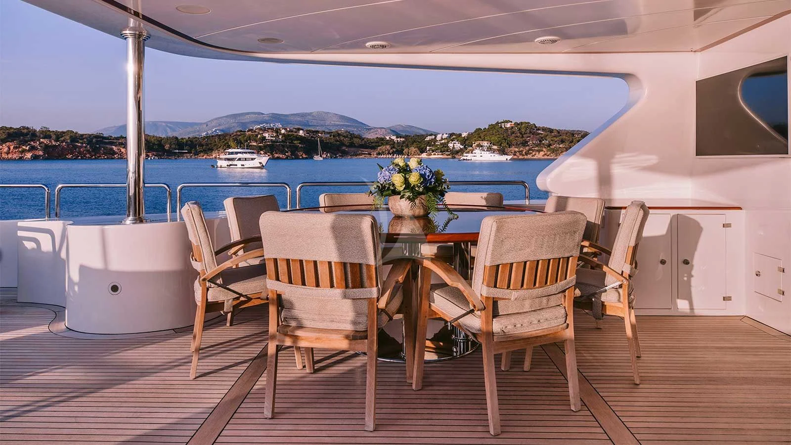 a table and chairs on a deck aboard OAK Yacht for Charter