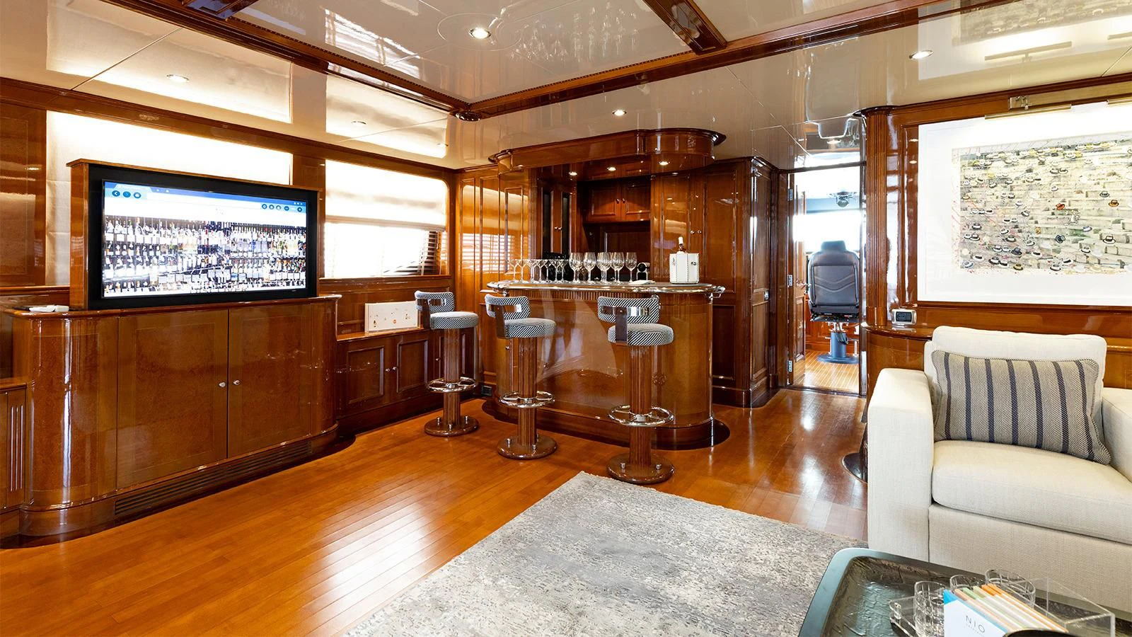a living room with a large screen aboard OAK Yacht for Charter