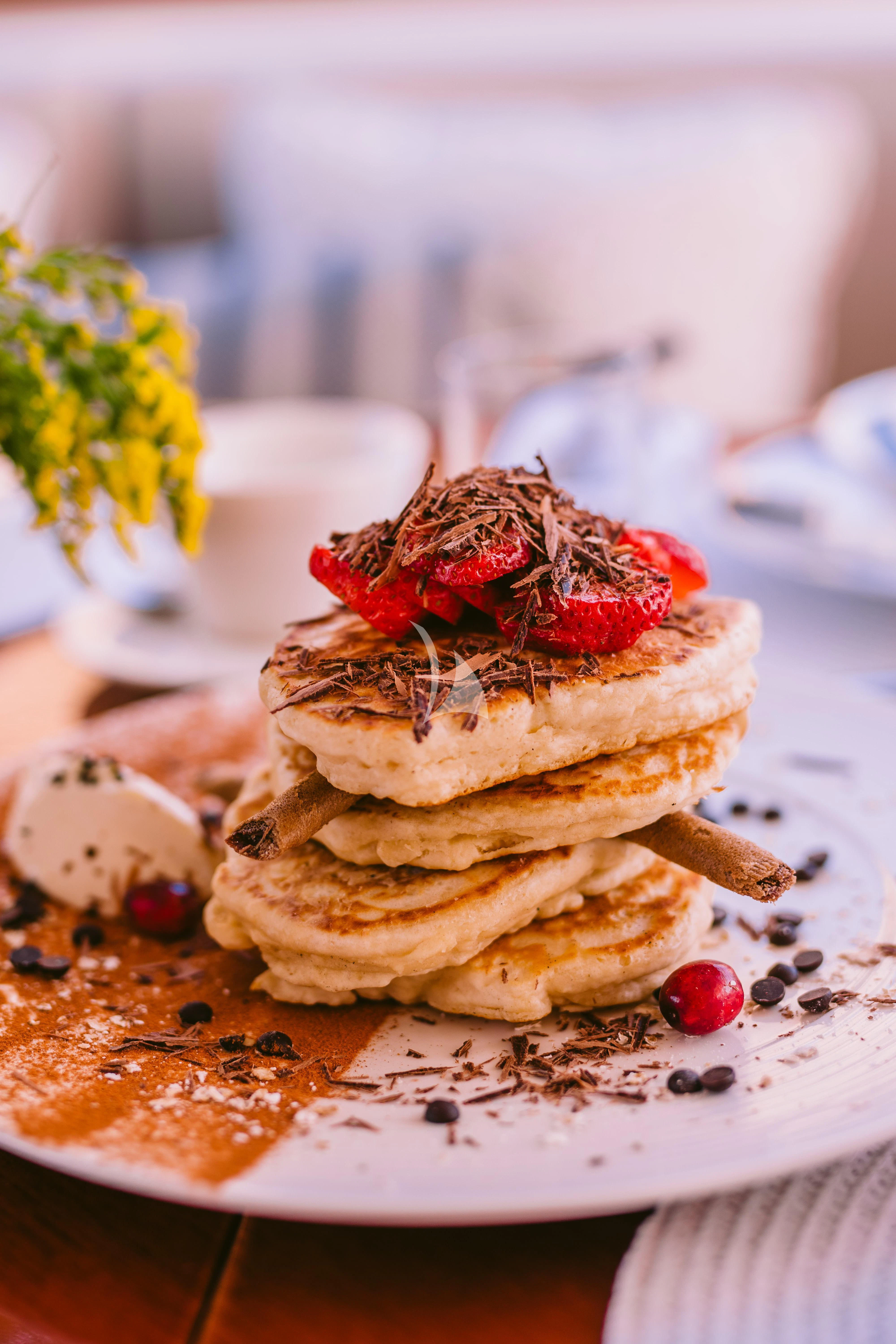 a plate of pancakes with fruit aboard OAK Yacht for Charter