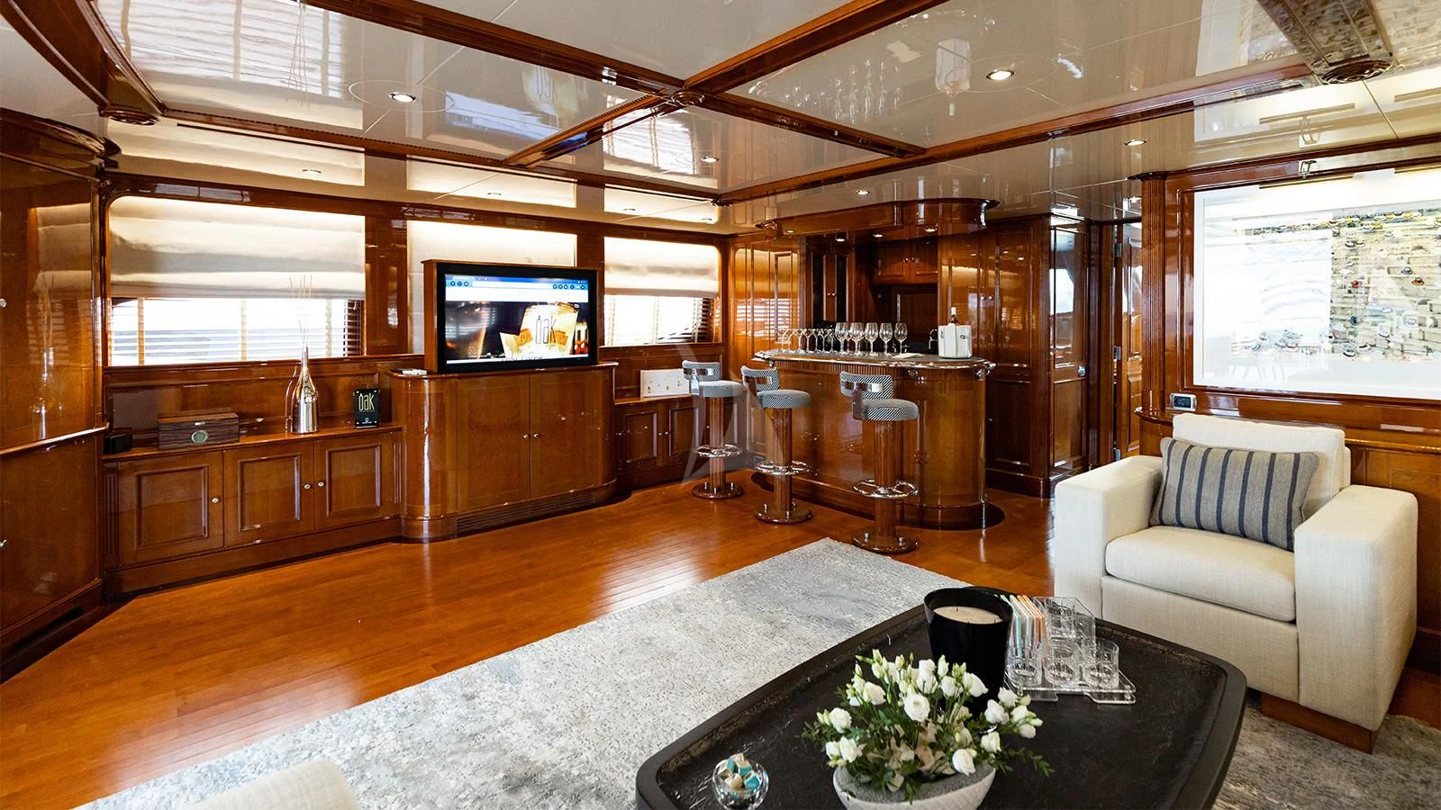 a living room with a large tv aboard OAK Yacht for Charter