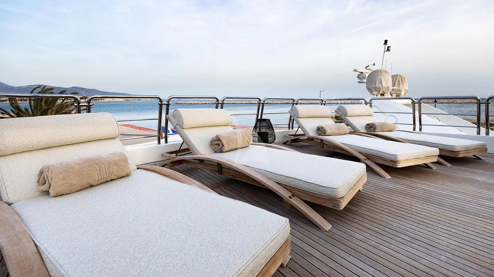 a deck with beds on it aboard OAK Yacht for Charter