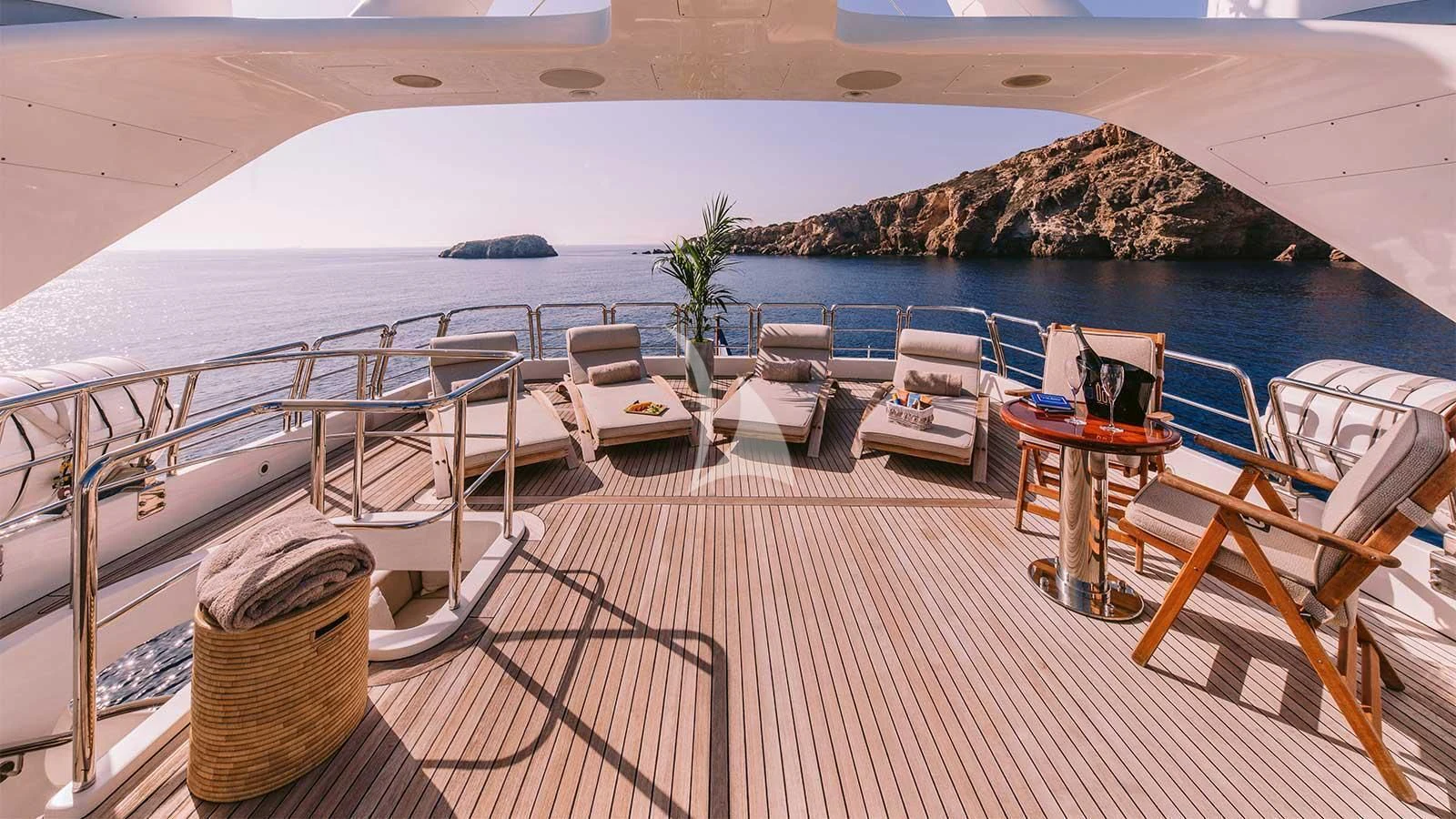 a deck with chairs and tables on it aboard OAK Yacht for Charter