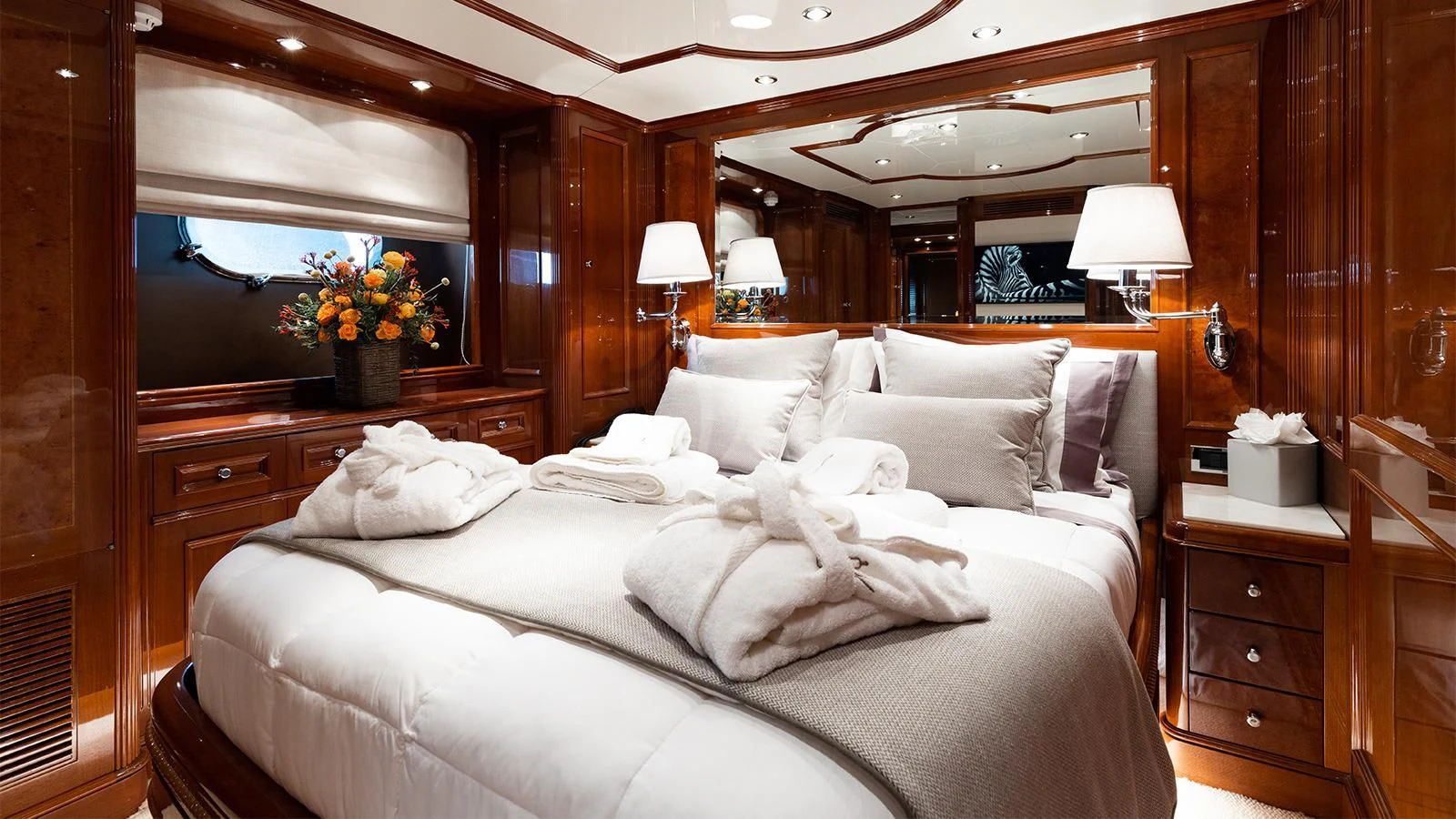 a bed with white sheets and pillows aboard OAK Yacht for Charter
