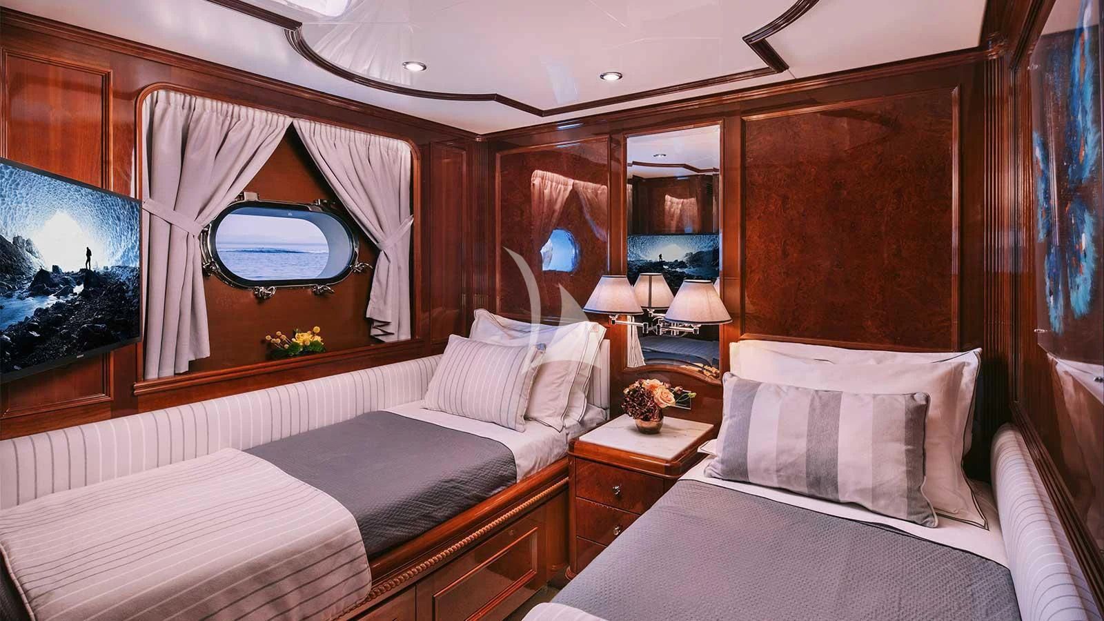 a room with a bed and a mirror aboard OAK Yacht for Charter