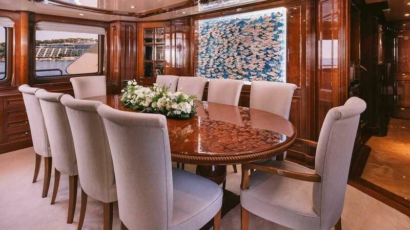 a dining table and chairs aboard OAK Yacht for Charter