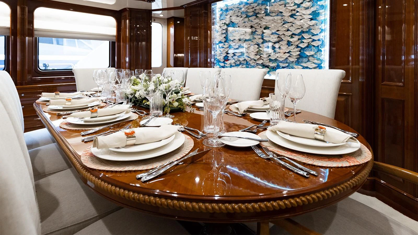 a table set with place settings aboard OAK Yacht for Charter