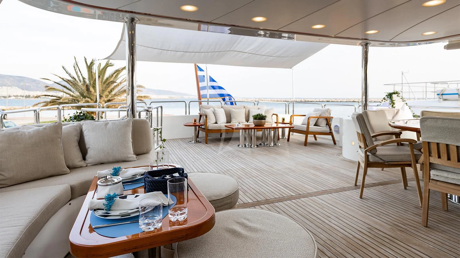 a living room with a couch and a table aboard OAK Yacht for Charter