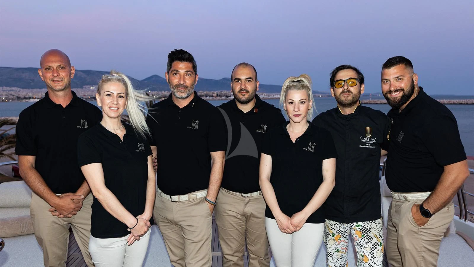 a group of people posing for a photo aboard OAK Yacht for Charter