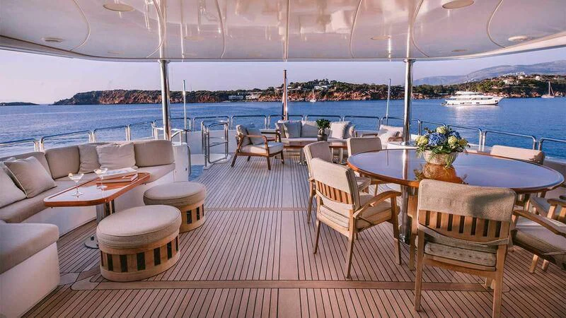 a room with tables and chairs aboard OAK Yacht for Charter