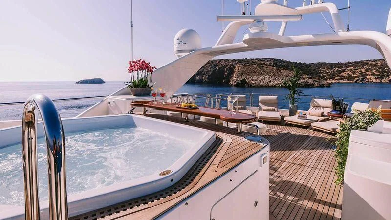 a deck with a pool and a large white building with a white dome aboard OAK Yacht for Charter