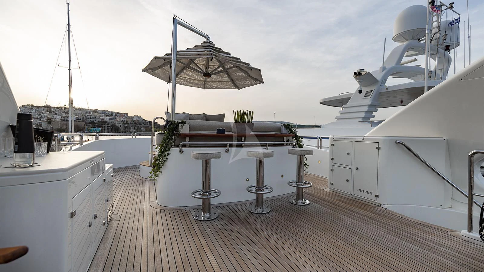 a deck with a table and chairs aboard OAK Yacht for Charter