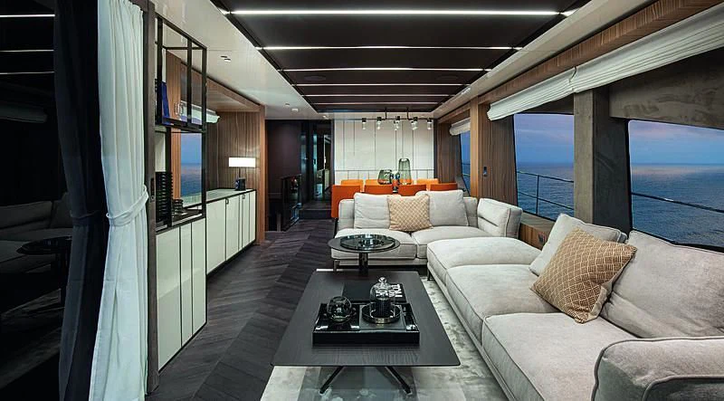 a living room with a couch and a table aboard CRANCHI SETTANTOTTO 78/01 Yacht for Sale