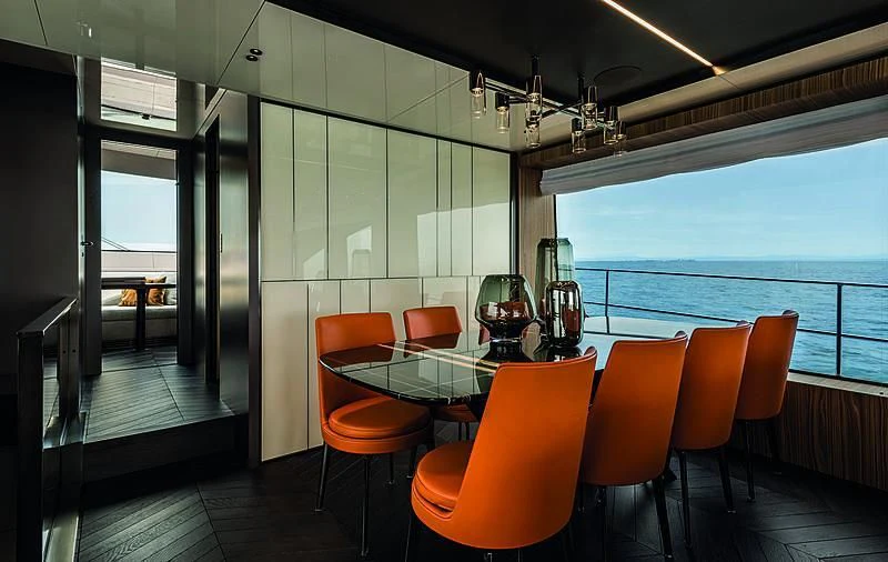 a room with a table and chairs aboard CRANCHI SETTANTOTTO 78/01 Yacht for Sale