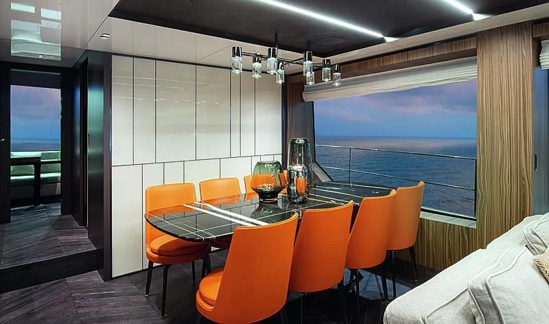 a room with a table and chairs aboard CRANCHI SETTANTOTTO 78/01 Yacht for Sale
