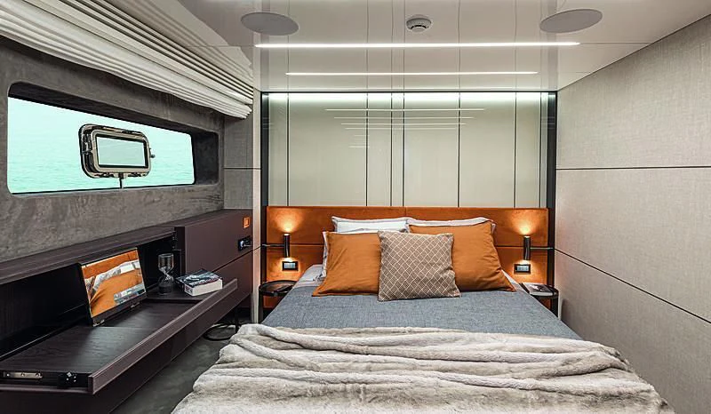 a bed with a television on the wall aboard CRANCHI SETTANTOTTO 78/01 Yacht for Sale