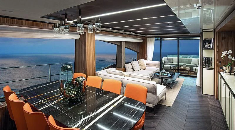 a large living room with a large balcony aboard CRANCHI SETTANTOTTO 78/01 Yacht for Sale