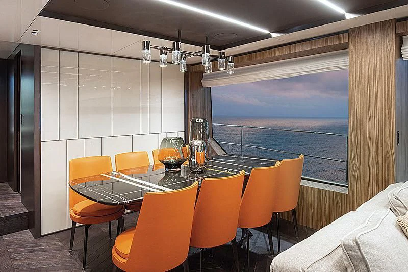 a room with a table and chairs aboard CRANCHI SETTANTOTTO 78/01 Yacht for Sale