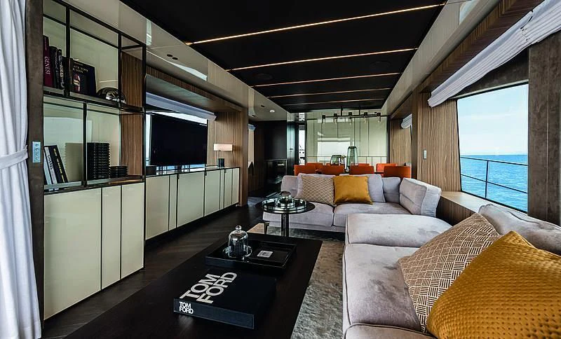 a living room with a black coffee table and white couches aboard CRANCHI SETTANTOTTO 78/01 Yacht for Sale