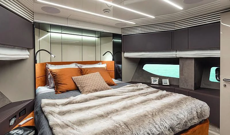 a bed with orange pillows aboard CRANCHI SETTANTOTTO 78/01 Yacht for Sale