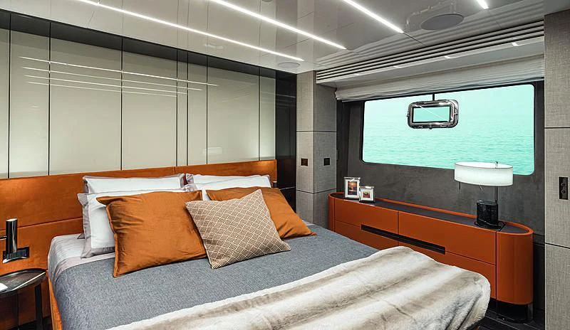 a bed with a white bed spread aboard CRANCHI SETTANTOTTO 78/01 Yacht for Sale