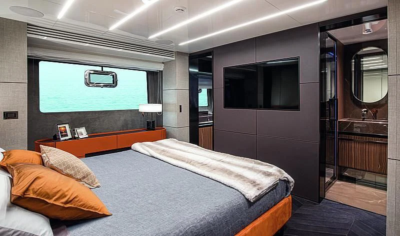 a bedroom with a bed and a tv on the wall aboard CRANCHI SETTANTOTTO 78/01 Yacht for Sale