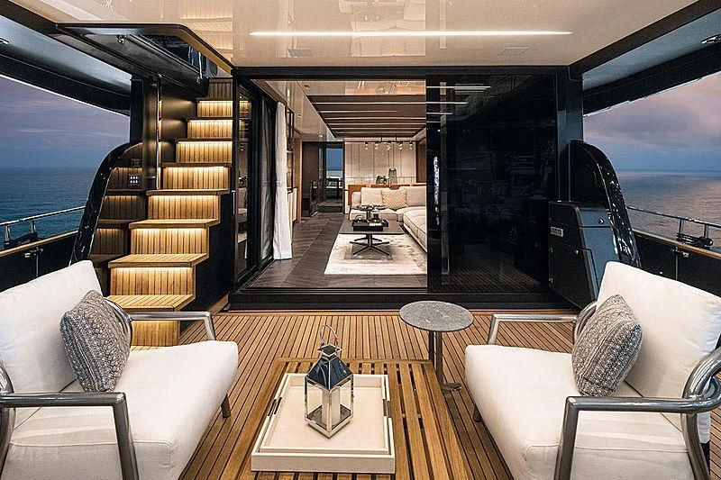 a room with a table chairs and a large window aboard CRANCHI SETTANTOTTO 78/01 Yacht for Sale