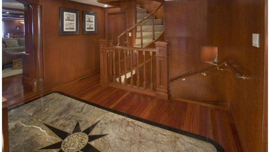a wood staircase in a room aboard STARGAZER Yacht for Sale