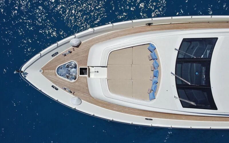 a white boat with a reflection of a person on it aboard LA ROMANA Yacht for Sale