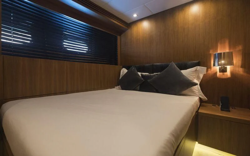 a bed with a white sheet and pillows aboard LA ROMANA Yacht for Sale