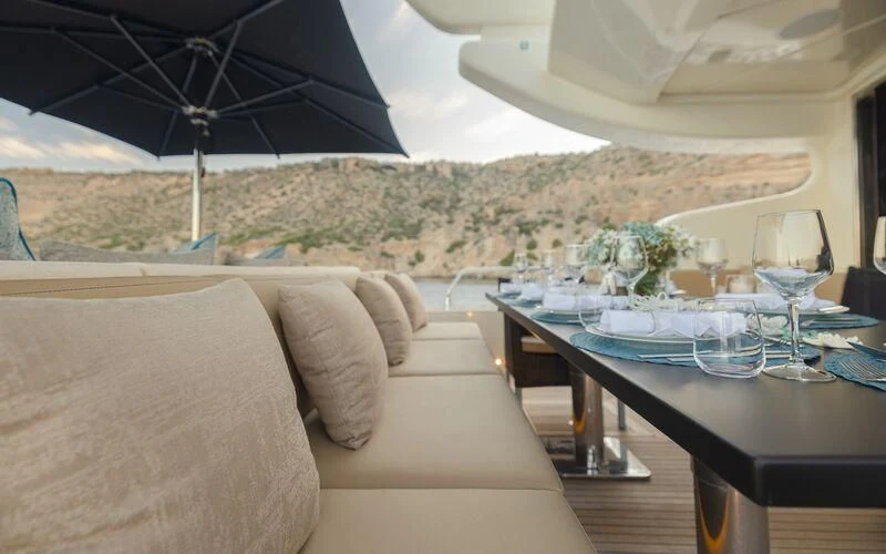 a table with a glass and an umbrella on it aboard LA ROMANA Yacht for Sale