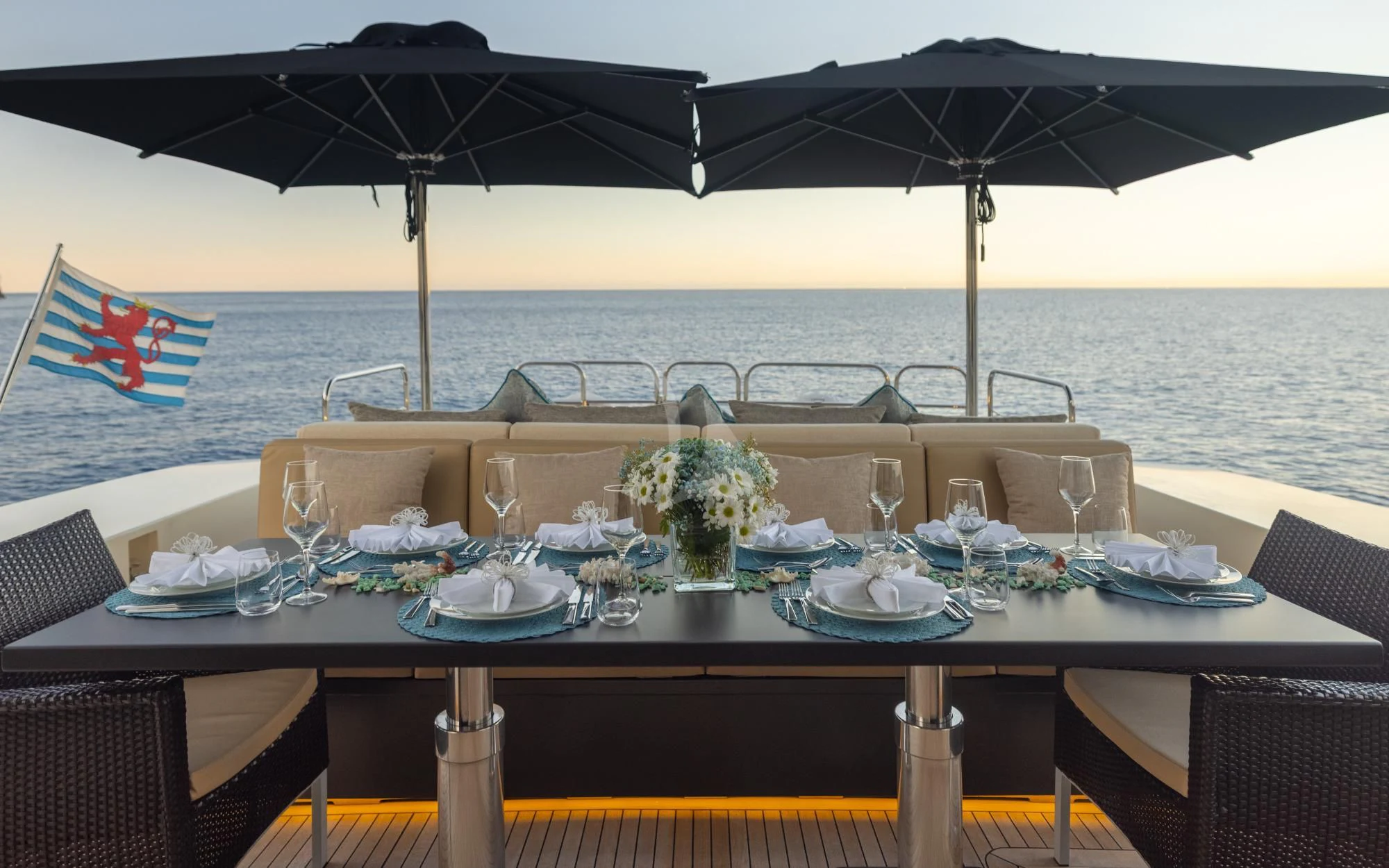 a table set with a large umbrella aboard LA ROMANA Yacht for Sale