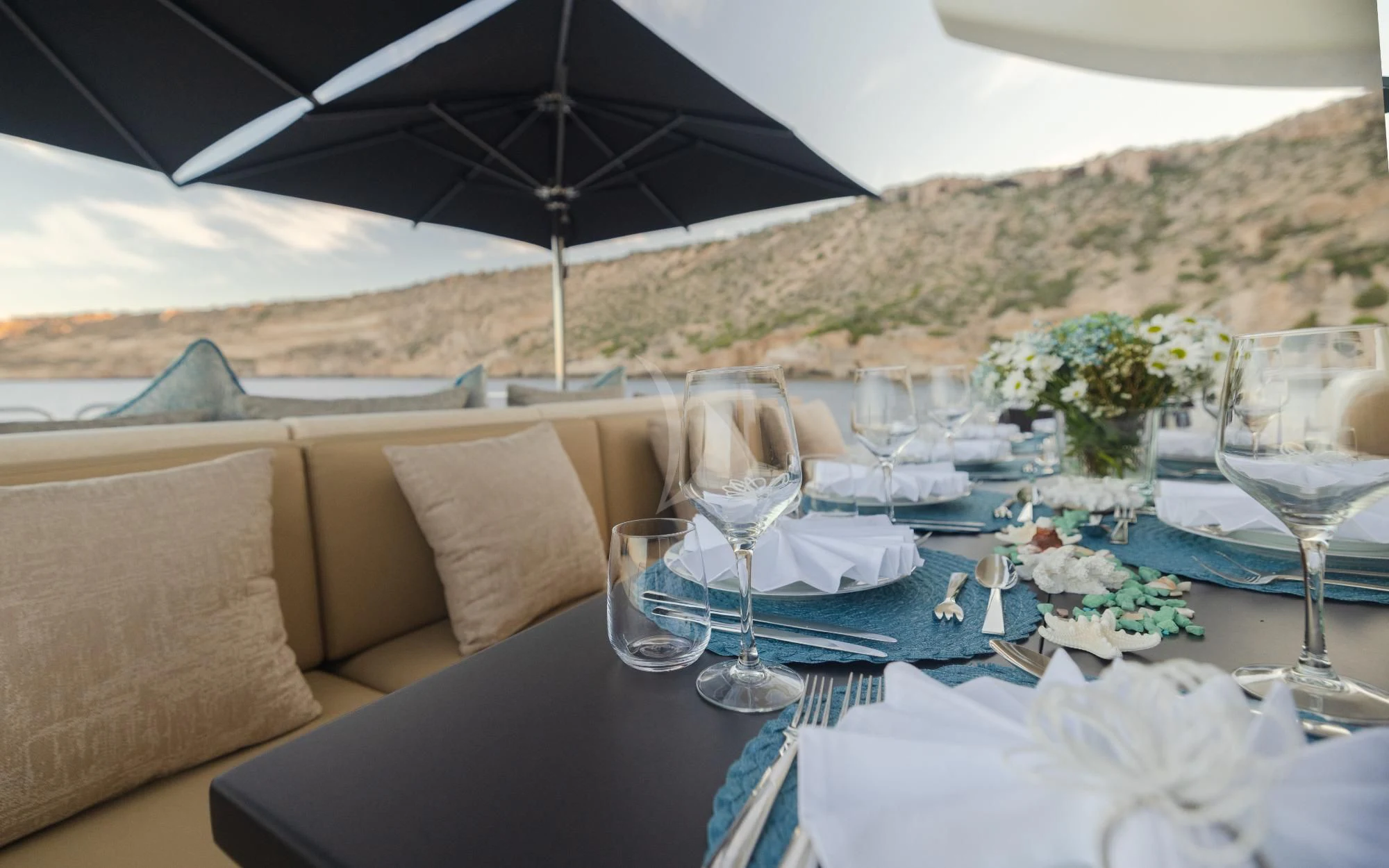 a table with plates and glasses aboard LA ROMANA Yacht for Sale