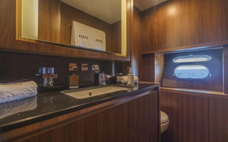 a kitchen with wooden cabinets aboard LA ROMANA Yacht for Sale