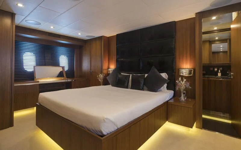 a room with a bed and a desk aboard LA ROMANA Yacht for Sale