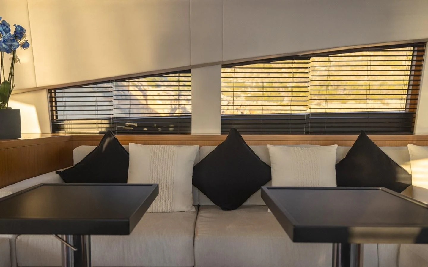 a room with white walls and black pillows aboard LA ROMANA Yacht for Sale
