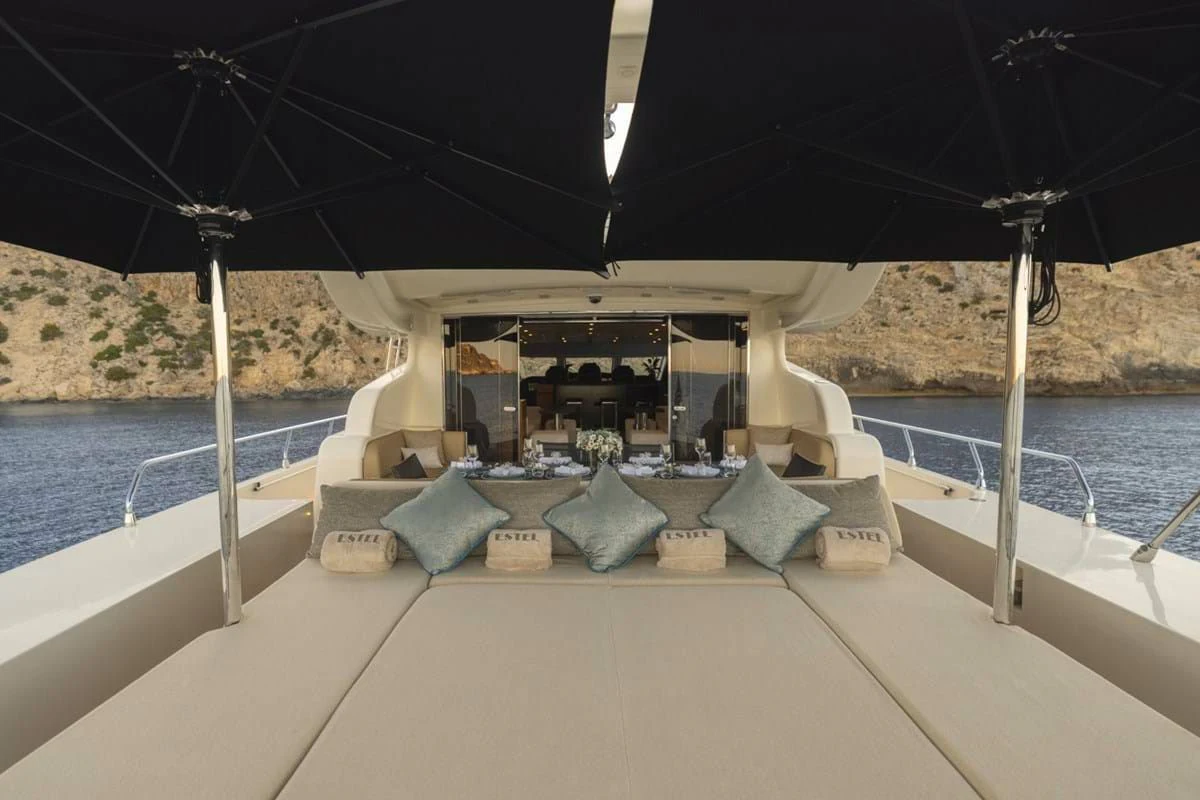 a lounge area with pillows and umbrellas on a boat aboard LA ROMANA Yacht for Sale