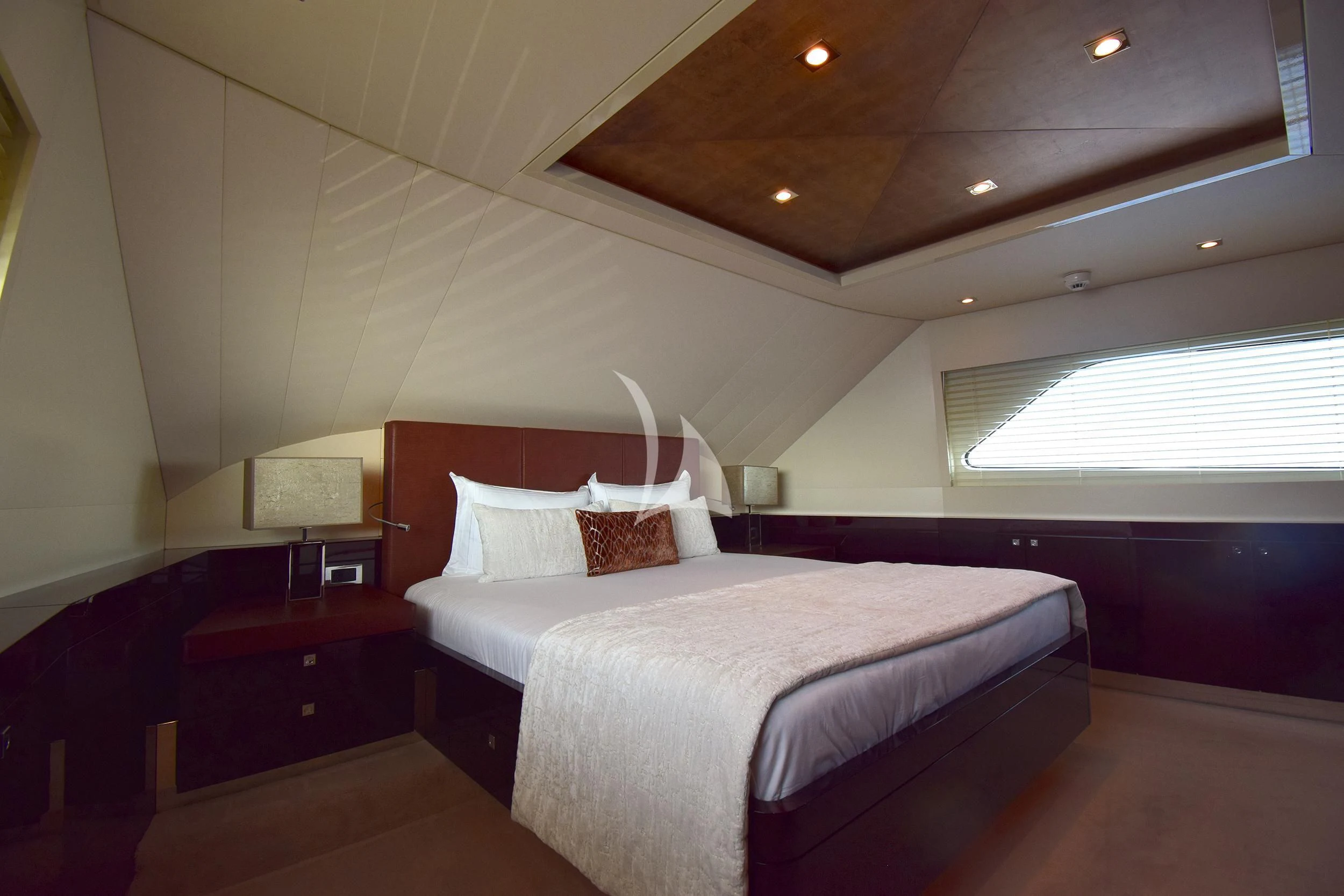 a bedroom with a bed and a desk aboard ORIZZONTE Yacht for Sale