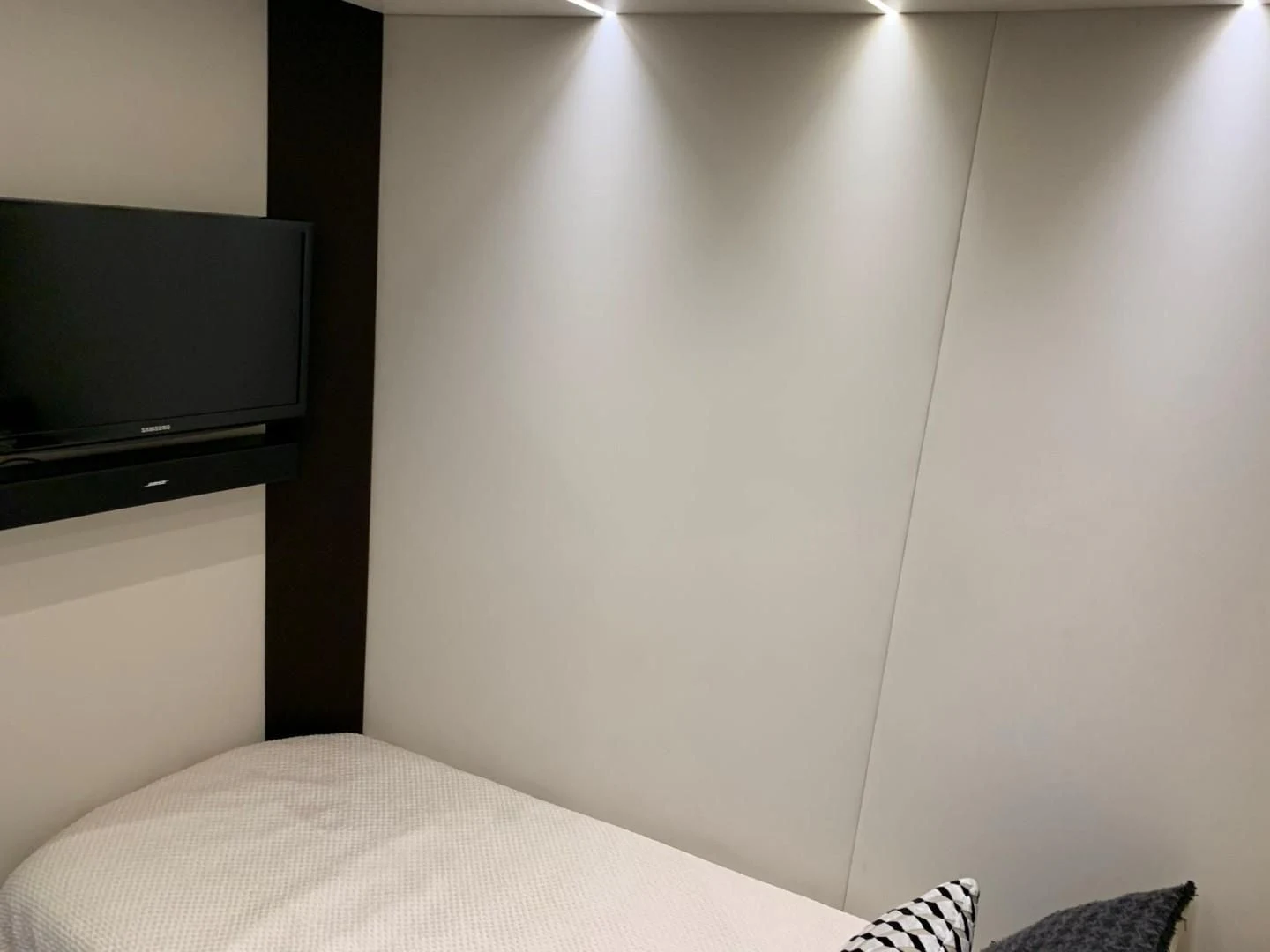 a white wall with a television on it aboard AMALFI Yacht for Sale