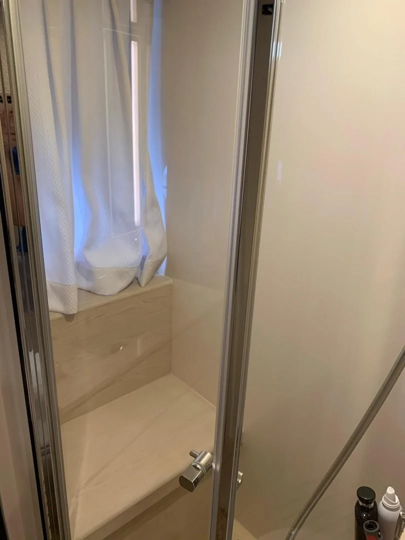 a shower curtain with a blue curtain aboard AMALFI Yacht for Sale