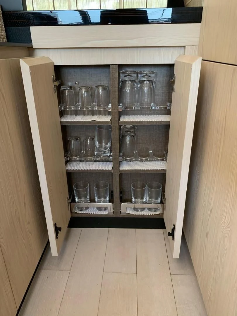 a cabinet with glasses and a glass on it aboard AMALFI Yacht for Sale