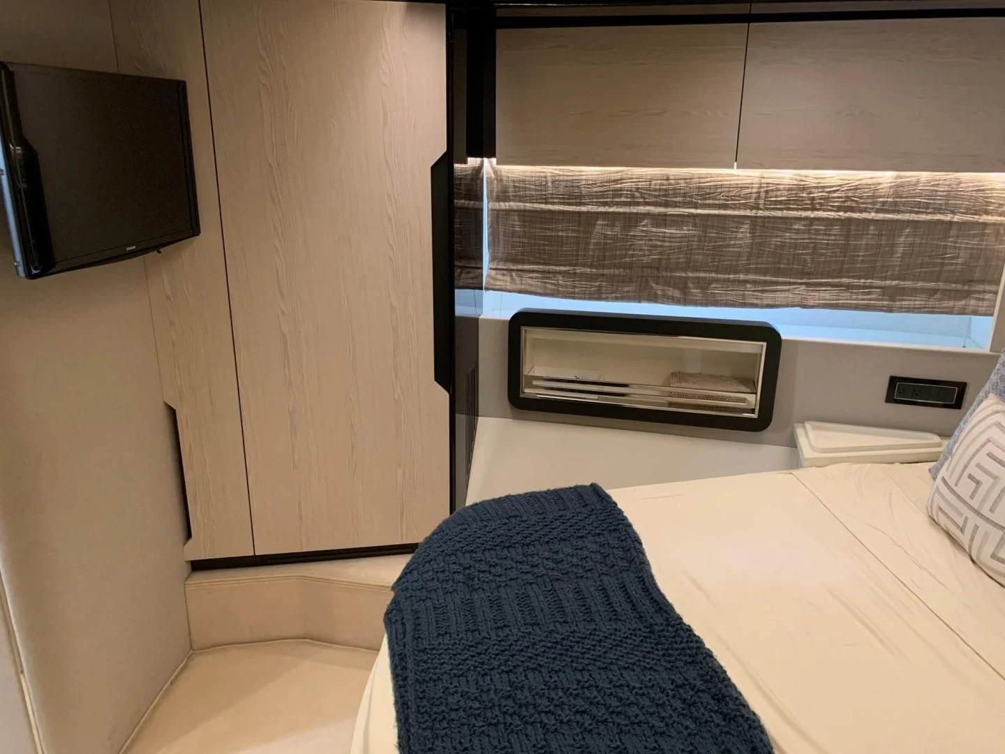 a room with a couch and a television aboard AMALFI Yacht for Sale
