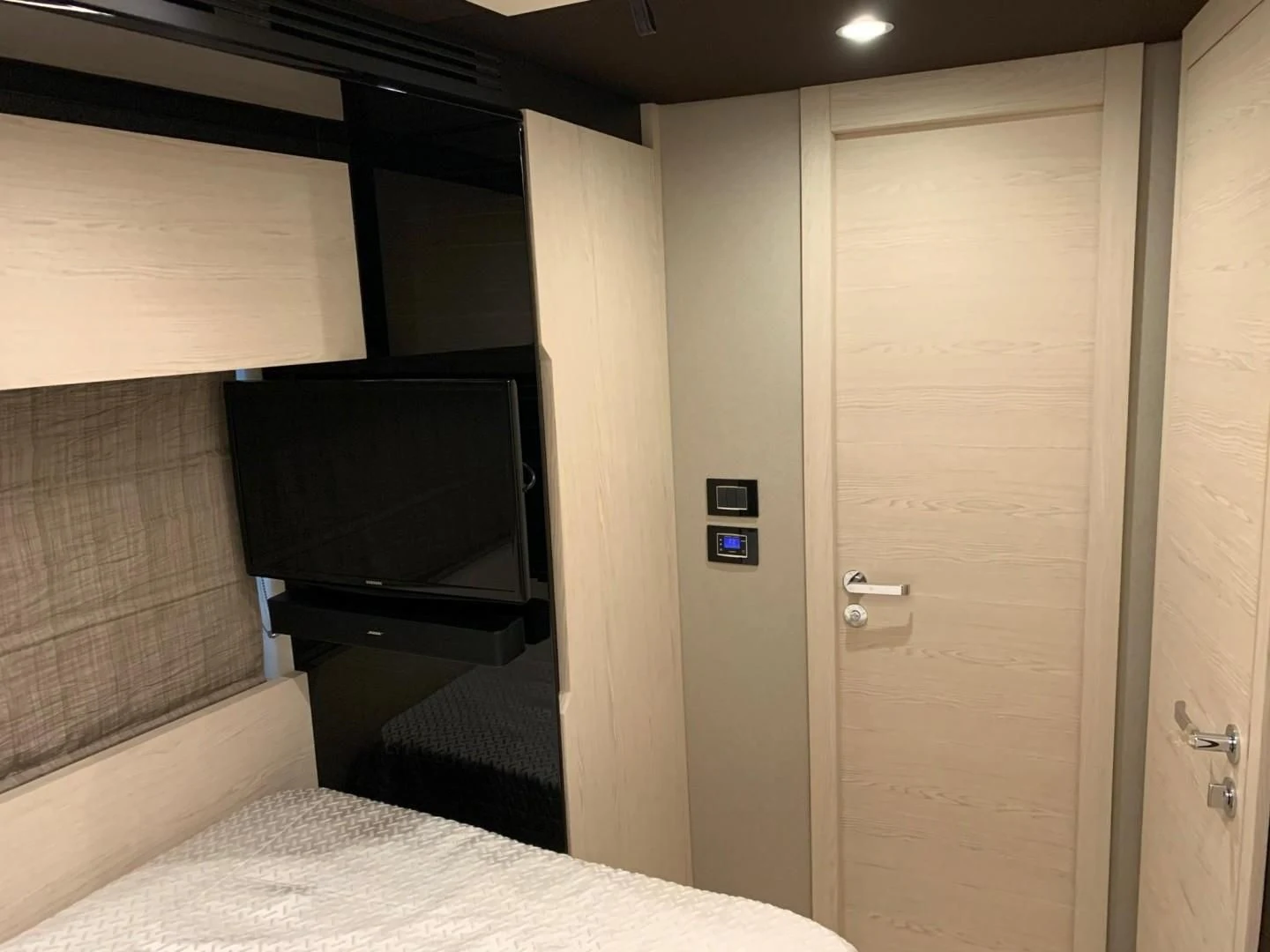 a room with a tv and a bed aboard AMALFI Yacht for Sale